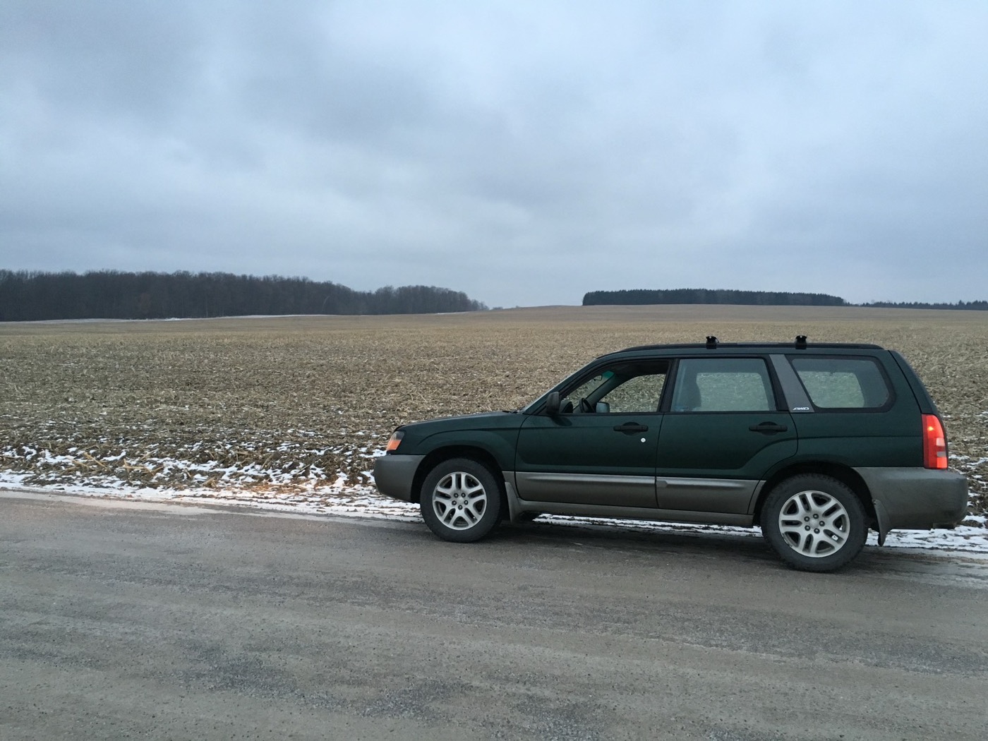 Green Forester XS on a snowy country road