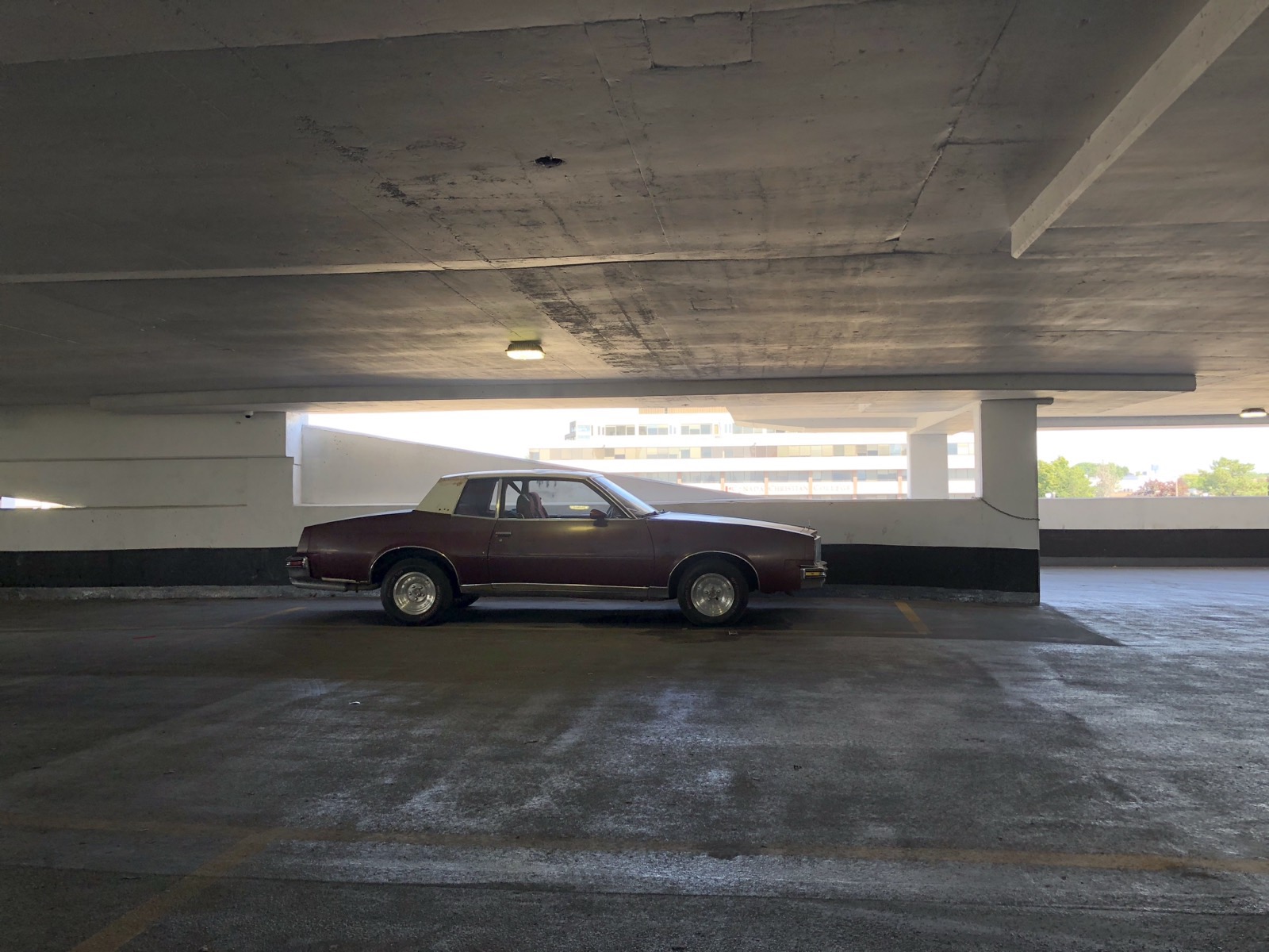 Grand Prix alone on the top deck of a parking garage