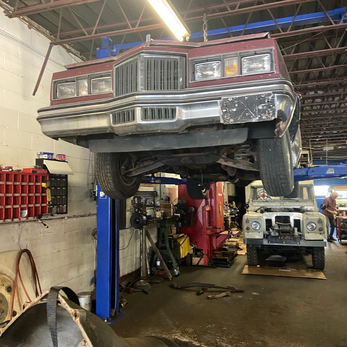 1978 Pontiac Grand Prix on a lift, front view, with a Land Rover behind